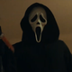 Ghostface raises a bloodied knife to the camera in a scene from the new Scream.
